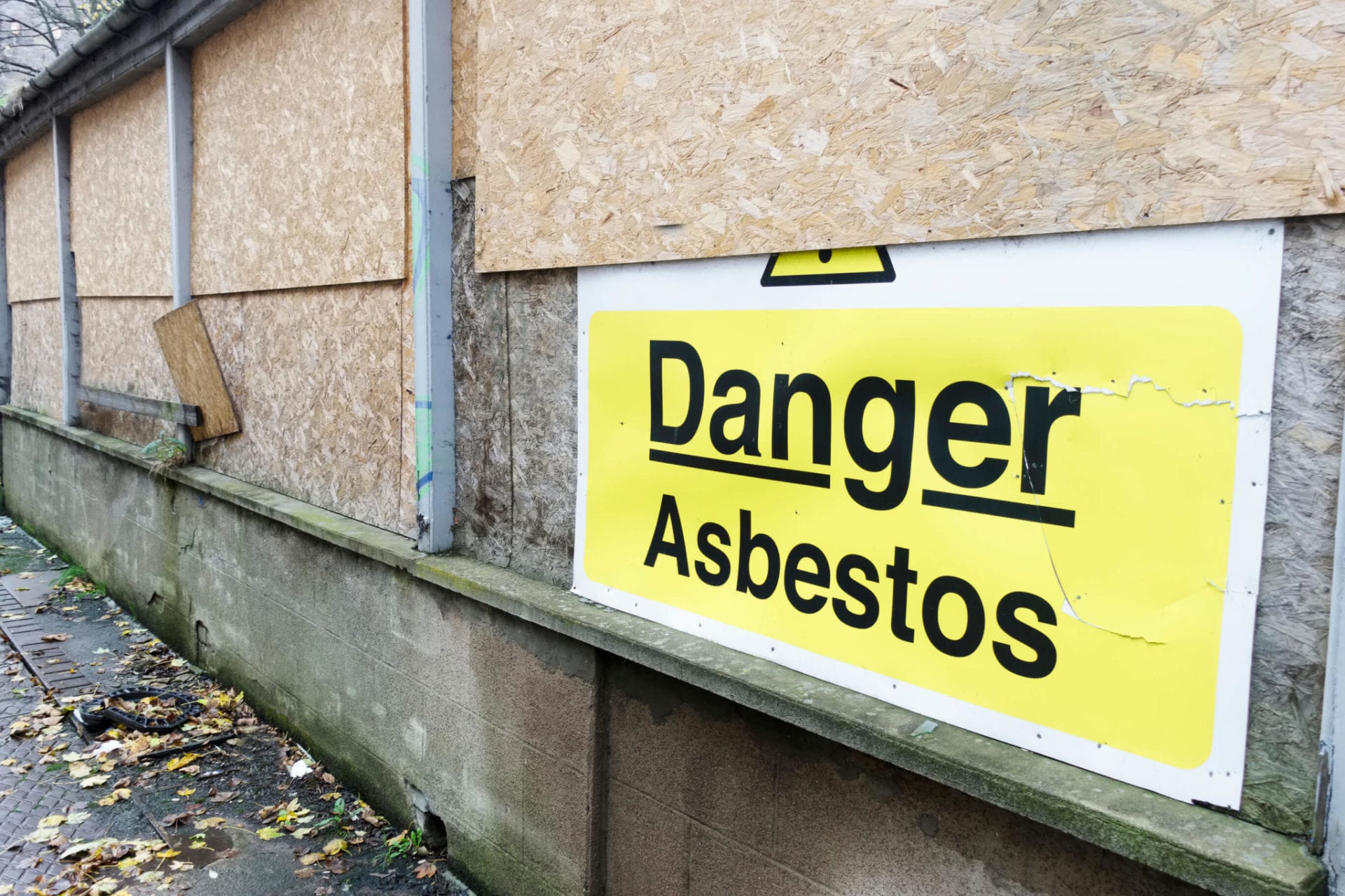 Asbestos danger sign at building construction site
